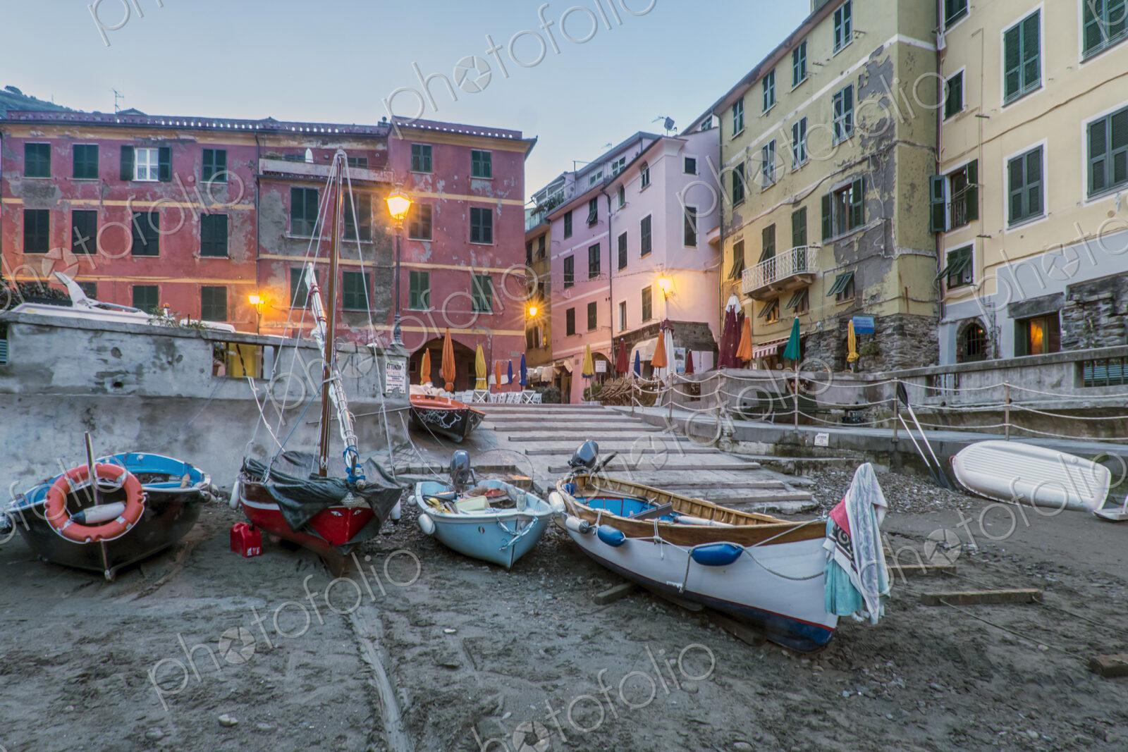 Beach and fishing boats on the shore at Le Spezia, a piazza and historic buildings, dawn