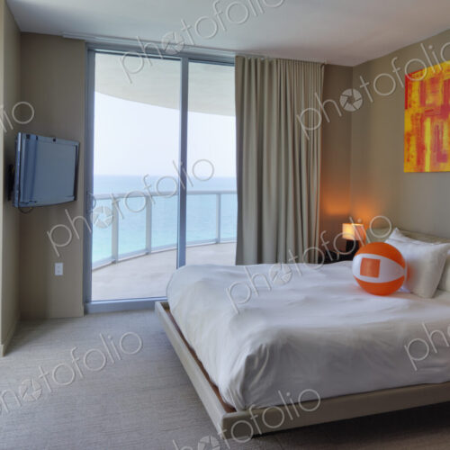 Beach ball on bed in hotel room