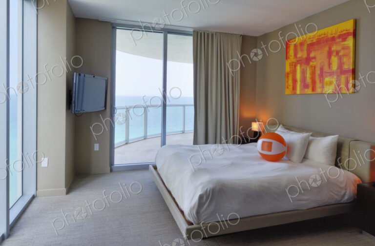 Beach ball on bed in hotel room