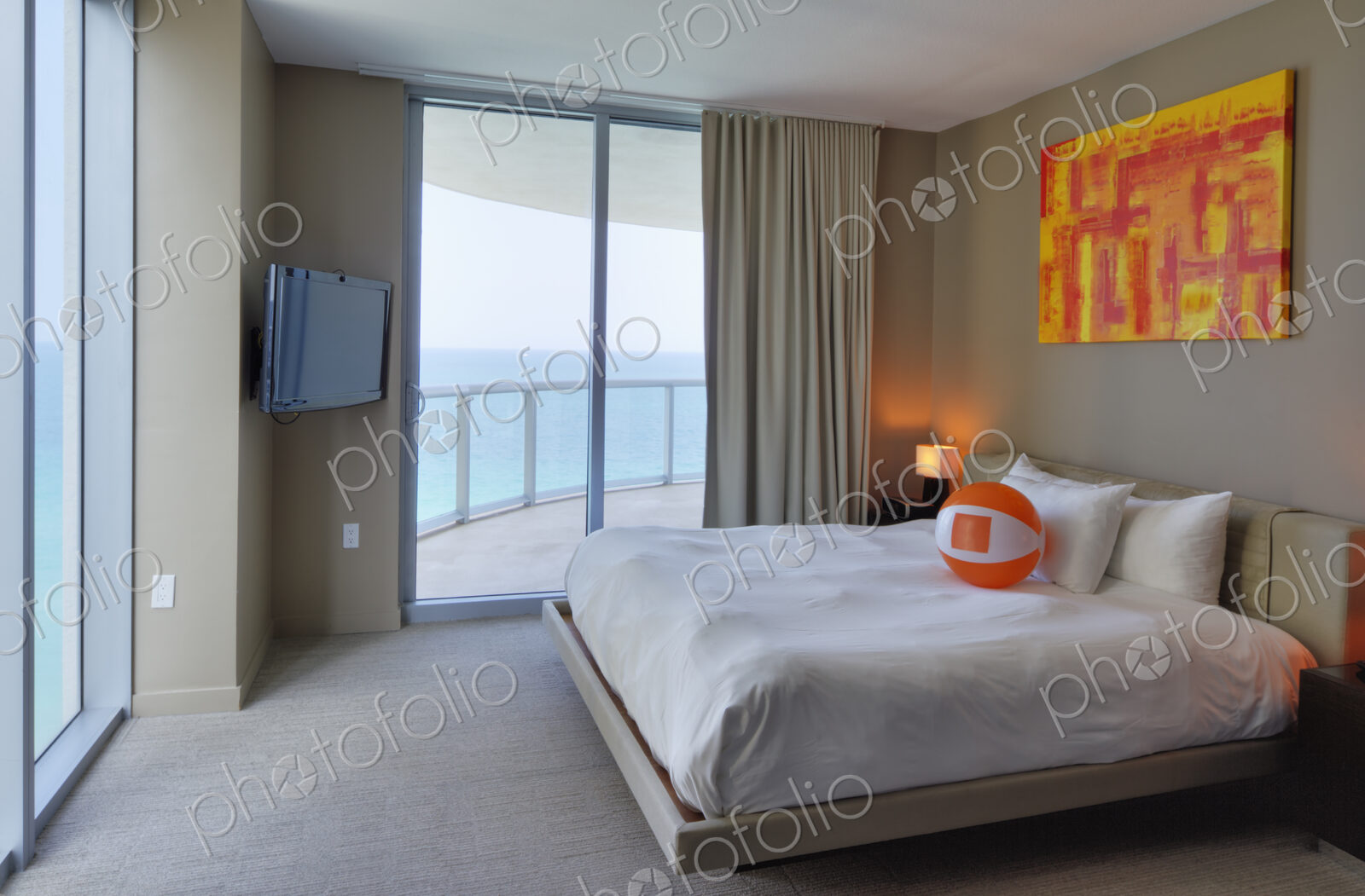 Beach ball on bed in hotel room