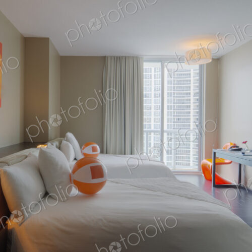 Beach balls on bed in hotel room Beach balls on bed in hotel room