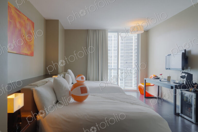 Beach balls on bed in hotel room