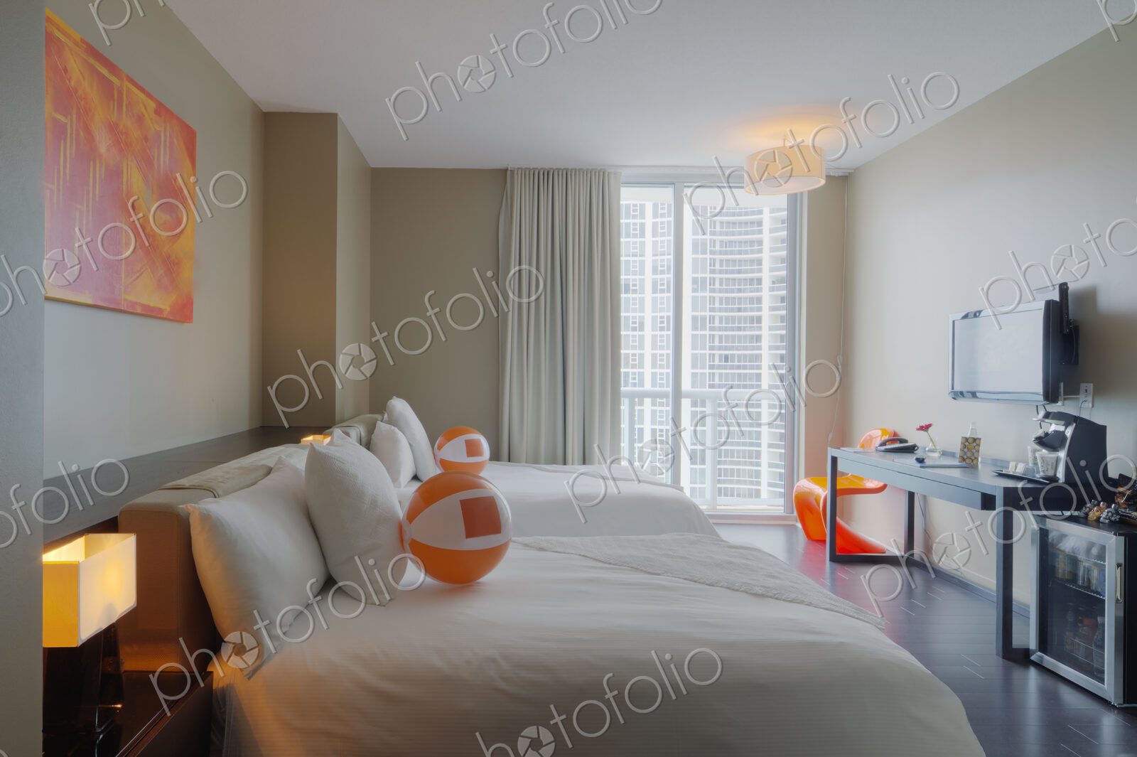 Beach balls on bed in hotel room