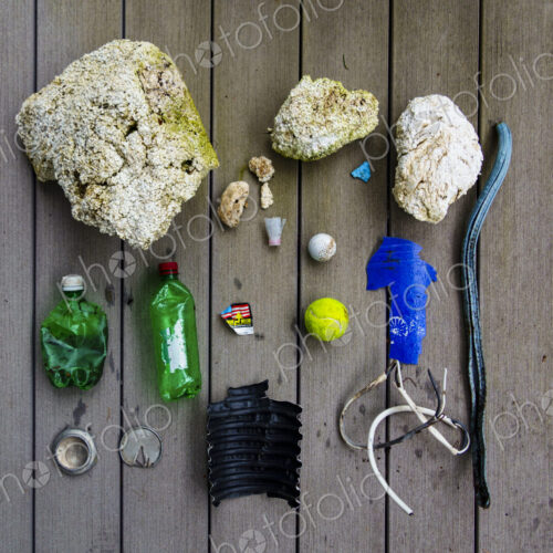 Beach debris, trash, a still life display on a board, jetsam. Beach debris, trash, a still life display on a board, jetsam.