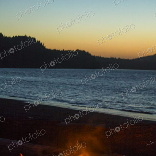 Beach fire on Puget Sound, Port Angeles, flames at dusk. Beach fire on Puget Sound, Port Angeles, flames at dusk.