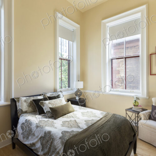 Bed and armchair in bedroom Bed and armchair in bedroom