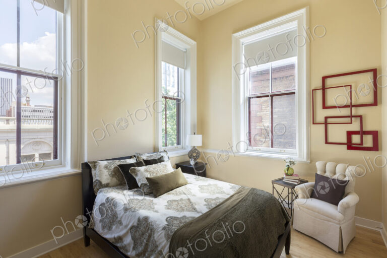 Bed and armchair in bedroom