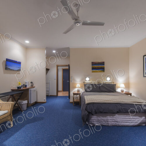 Bed and armchair in hotel room Bed and armchair in hotel room