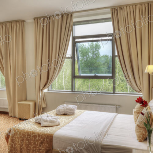 Bed and curtains in hotel room