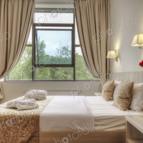 Bed and curtains in hotel room