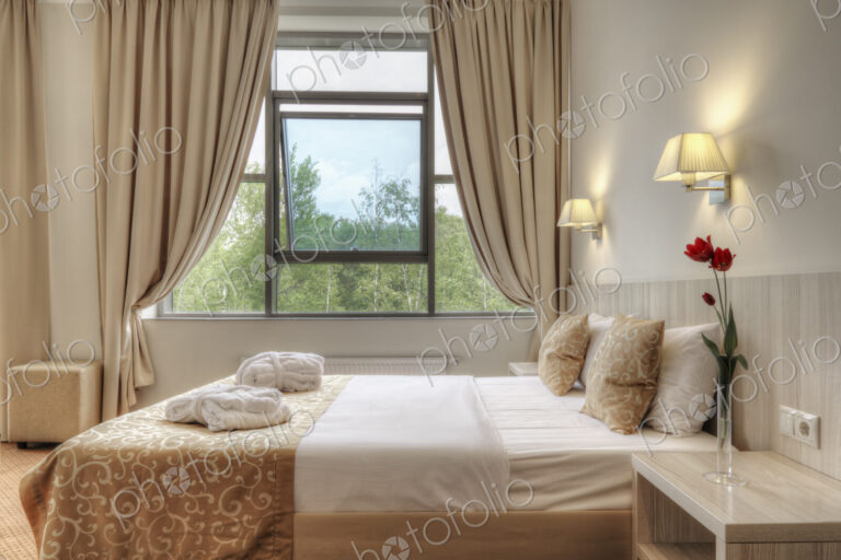 Bed and curtains in hotel room