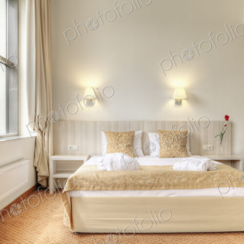 Bed and curtains in hotel room