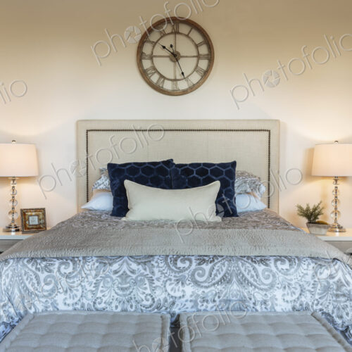 Bed and lamps in ornate bedroom