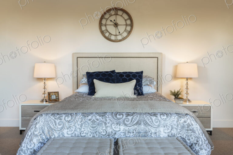 Bed and lamps in ornate bedroom