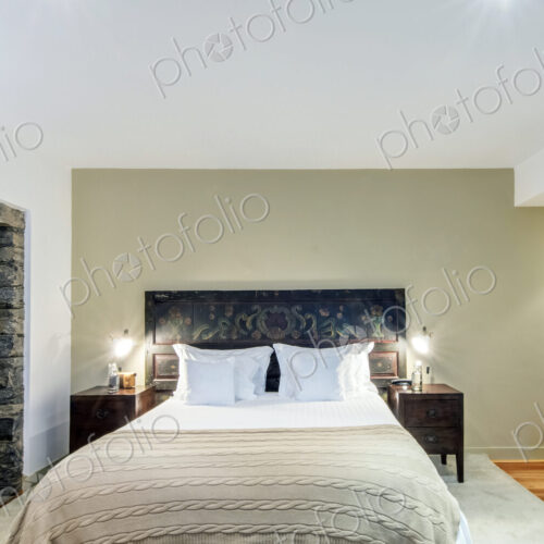 Bed and night tables in hotel room Bed and night tables in hotel room