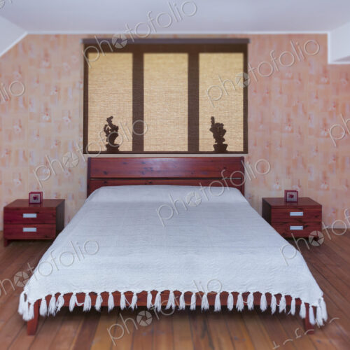Bedroom interior with large bed, furniture and bedside tabel. Shadows on roller blind. Bedroom interior with large bed, furniture and bedside tabel. Shadows on roller blind.