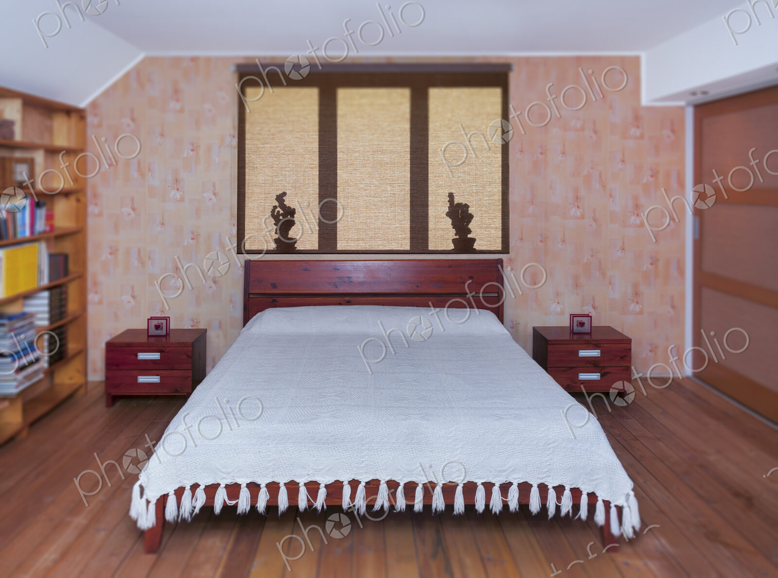 Bedroom interior with large bed, furniture and bedside tabel. Shadows on roller blind.