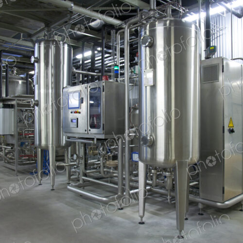 Beer brewing production plant. Large storage and fermenting tanks, stainless steel…