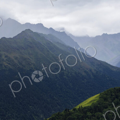 Belang mountains, the steep peaks of the mountain range, mist low over the tops. Belang mountains, the steep peaks of the mountain range, mist low over the tops.