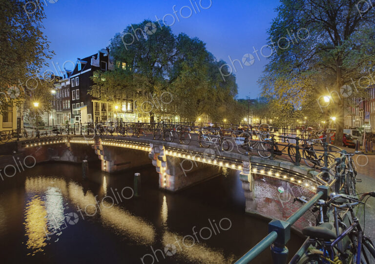 Bicycles Parked on Bridge Over Canal