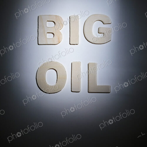 Big Oil sign, lettering on a plain surface, shadows, studio shot