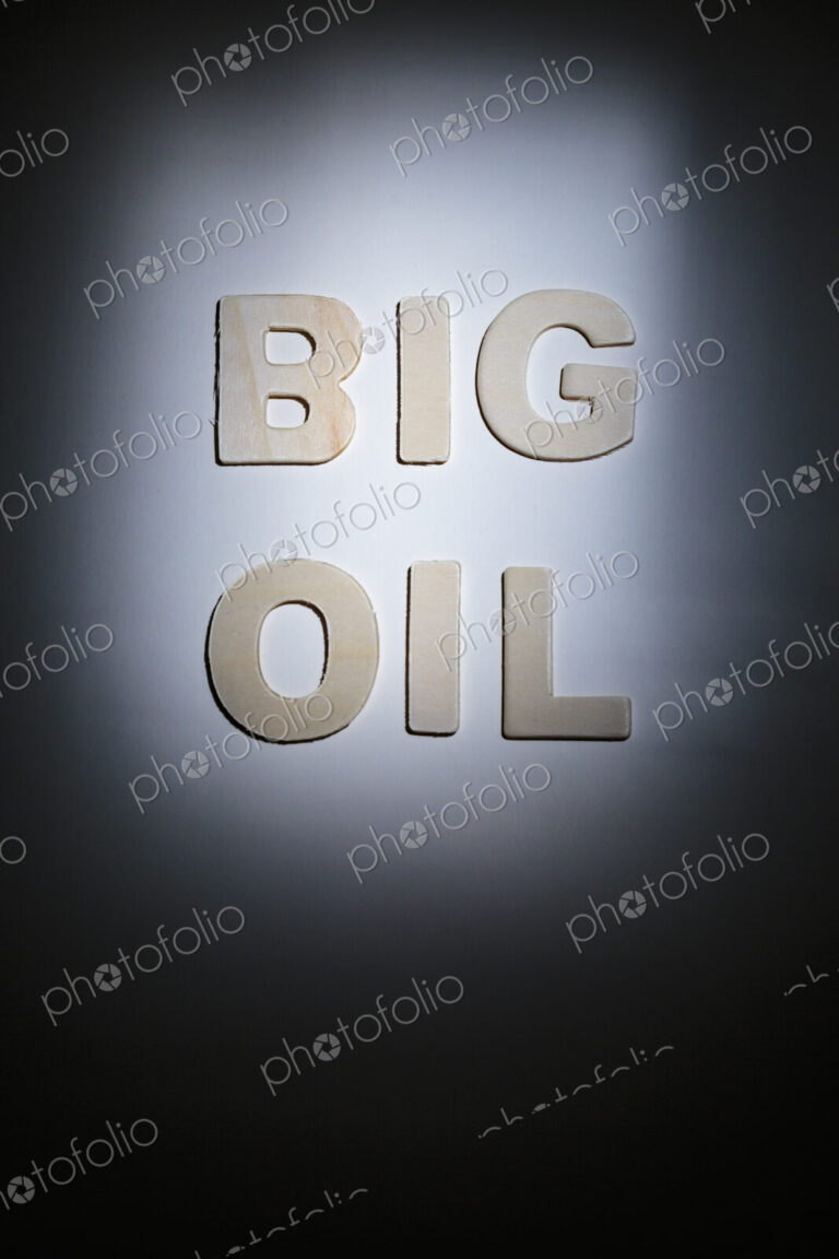 Big Oil sign, lettering on a plain surface, shadows, studio shot