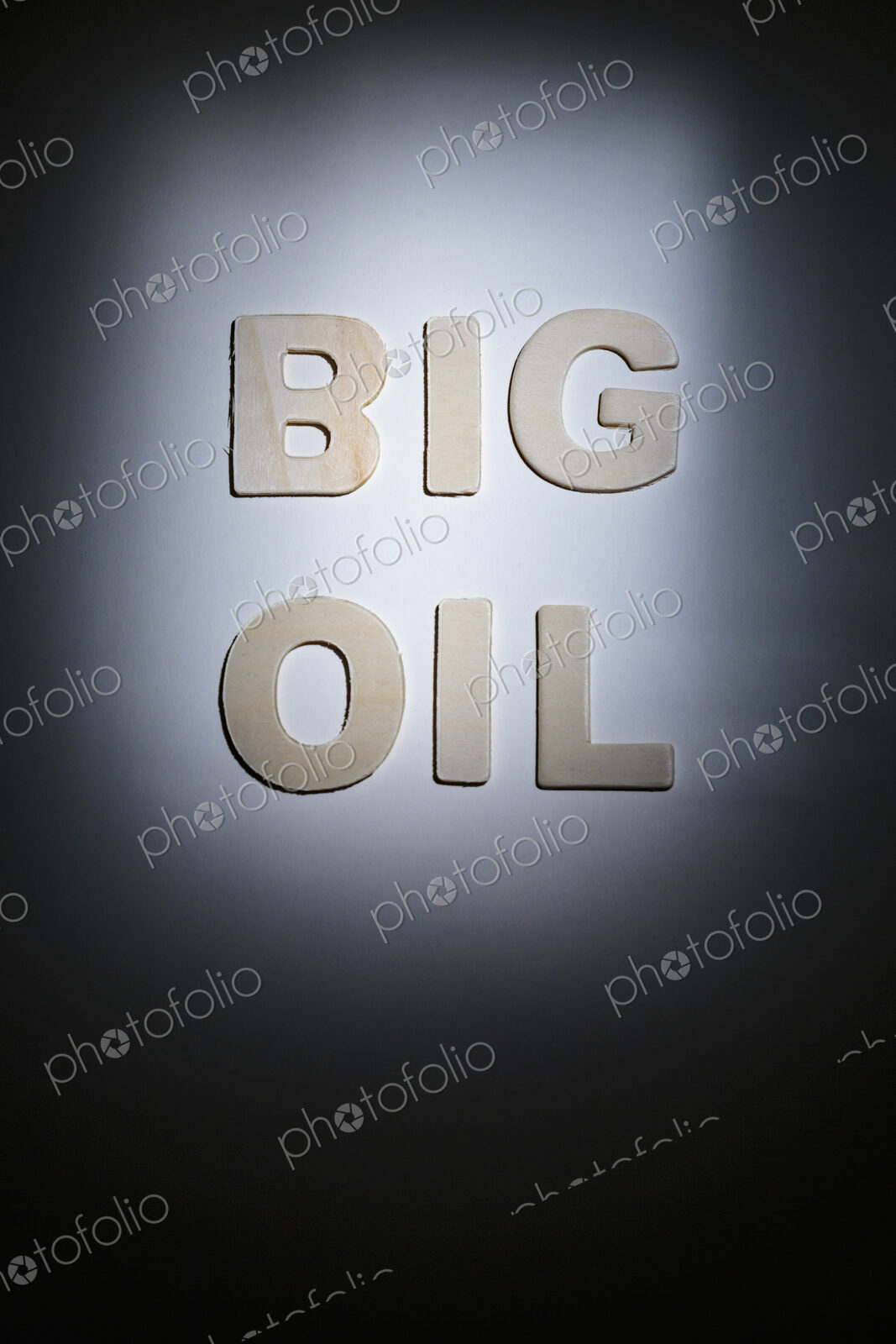 Big Oil sign, lettering on a plain surface, shadows, studio shot