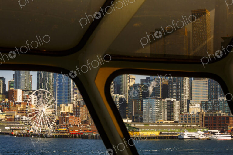 Big Wheel and Downtown Seattle views from a Puget Sound ferry window, Seattle, WA USA