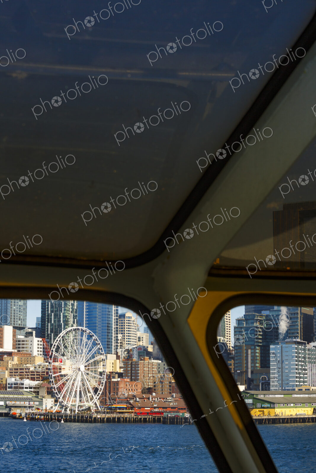 Big Wheel and Downtown Seattle views from a Puget Sound ferry window, Seattle, WA USA