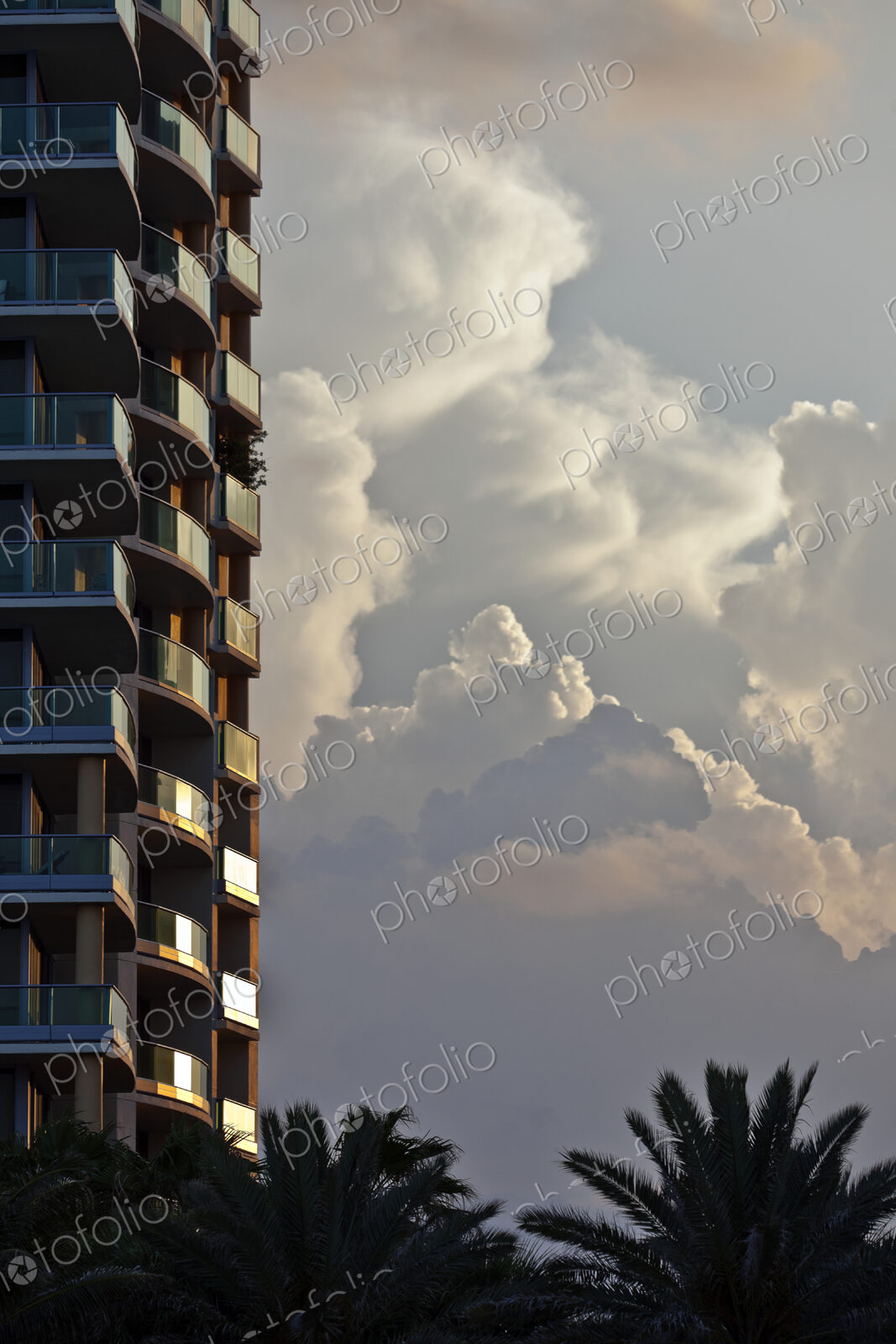 Billowing Clouds Behind a Tall Hotel