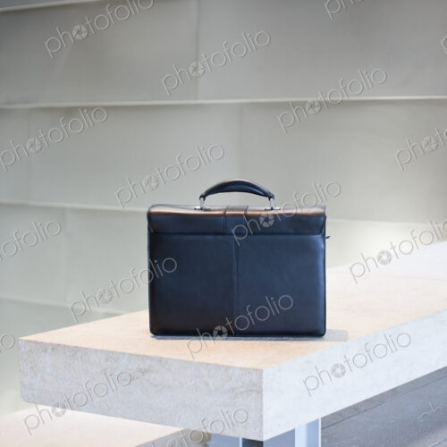 Black Briefcase on White Stone Bench Black Briefcase on White Stone Bench
