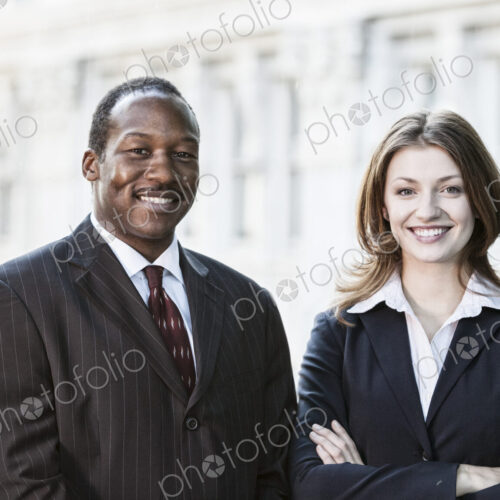 Black business man and caucasian business woman together in front of an older office… Black business man and caucasian business woman together in front of an older office…