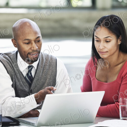 Black business man and mixed race caucasian woman in a business center meeting. Black business man and mixed race caucasian woman in a business center meeting.