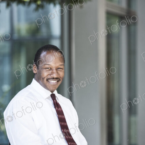 Black business man in a lobby waiting area. Black business man in a lobby waiting area.