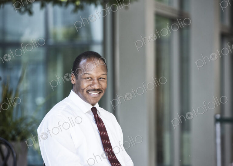 Black business man in a lobby waiting area.