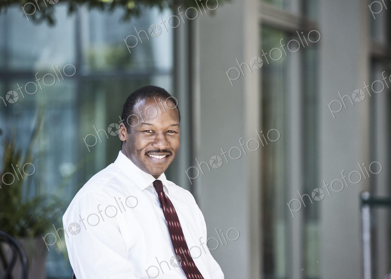 Black business man in a lobby waiting area.
