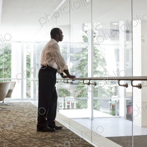 Black businessman in lobby of large business center. Black businessman in lobby of large business center.