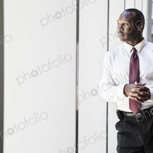 Black businessman in lobby of large business center.