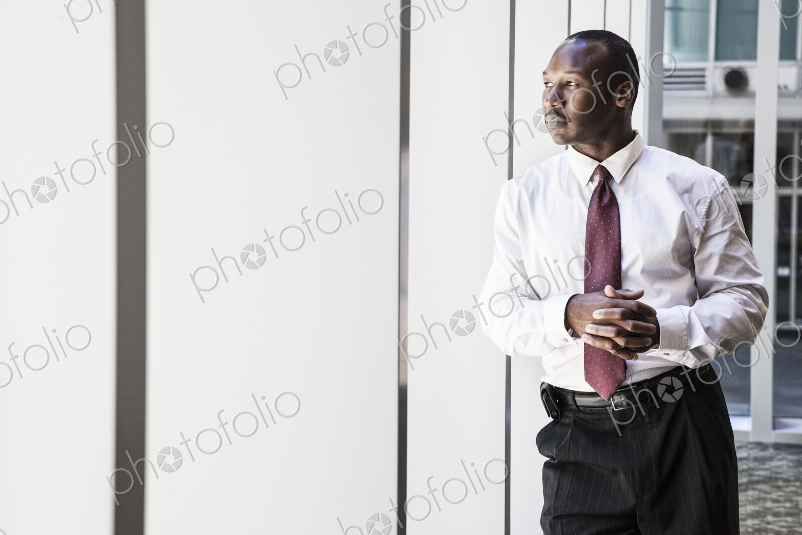Black businessman in lobby of large business center.