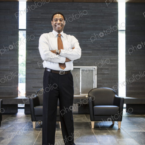 Black businessman in the lobby of a large office building. Black businessman in the lobby of a large office building.