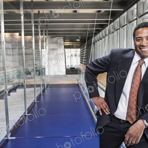 Black businessman in the lobby of a large office building. Black businessman in the lobby of a large office building.