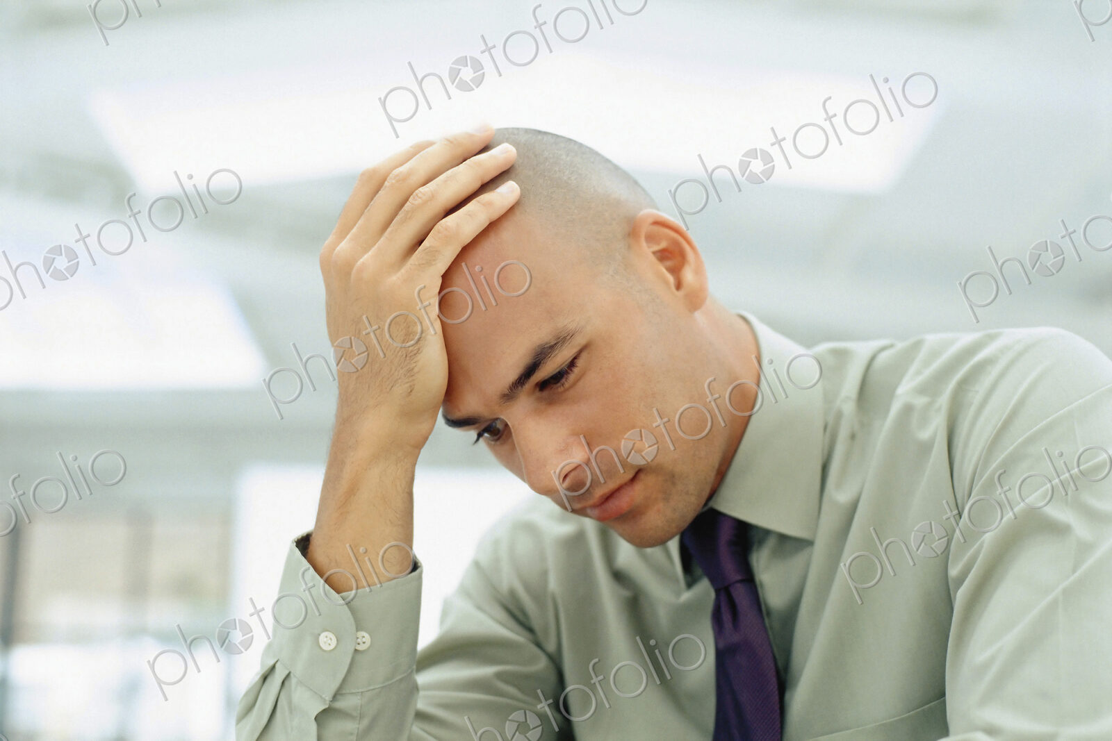 Black businessman rubbing his head