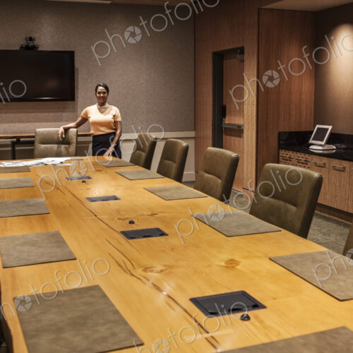 Black businesswoman at the head of a large conference table. Black businesswoman at the head of a large conference table.