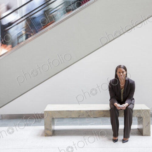 Black businesswoman holding a cell phone