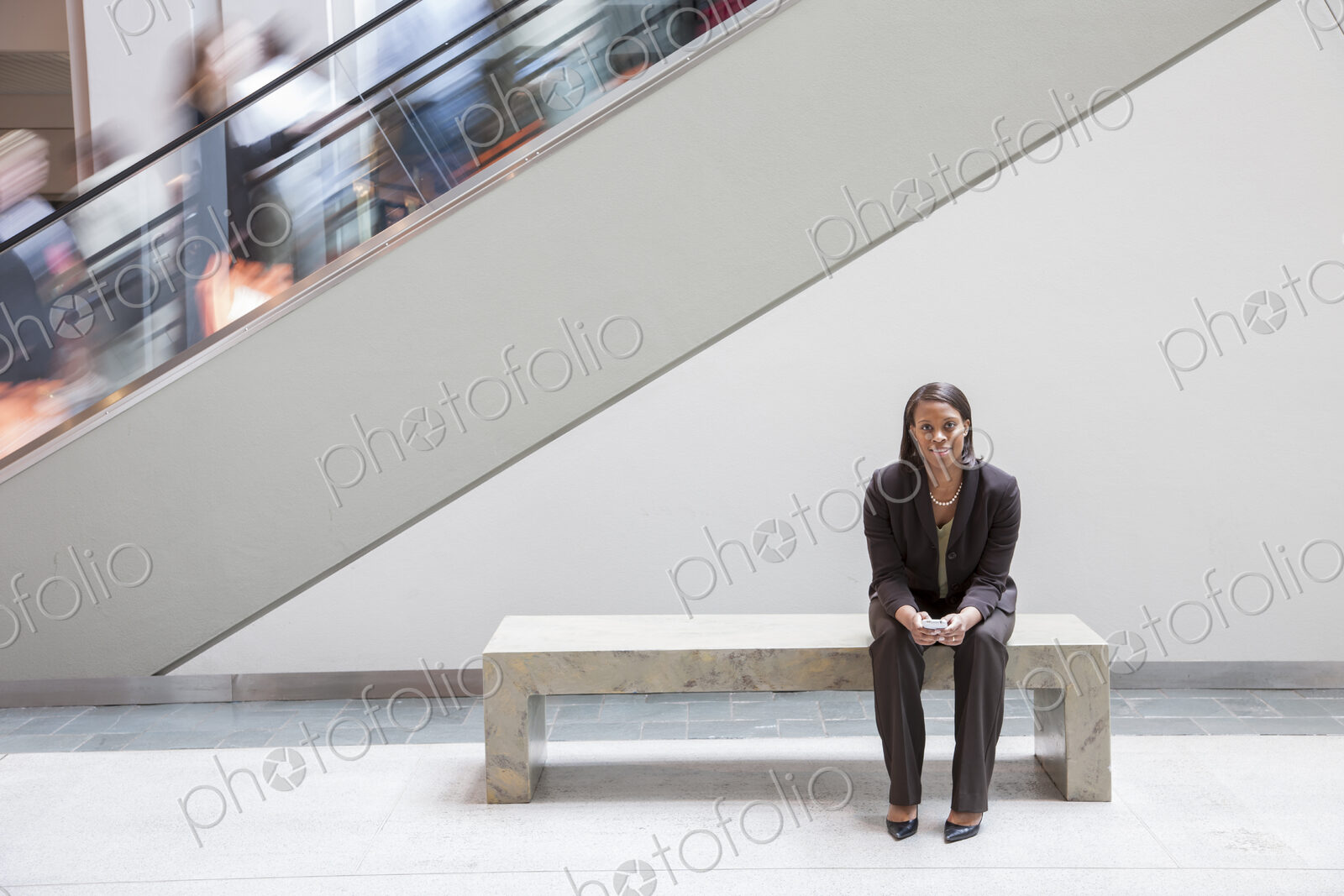 Black businesswoman holding a cell phone