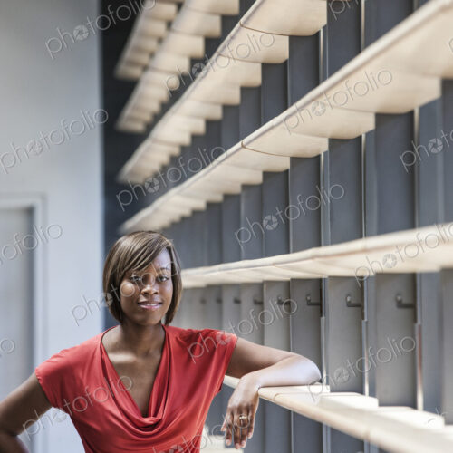 Black businesswoman in the lobby of a large office building. Black businesswoman in the lobby of a large office building.