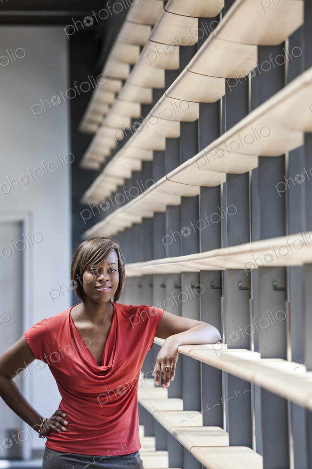 Black businesswoman in the lobby of a large office building.