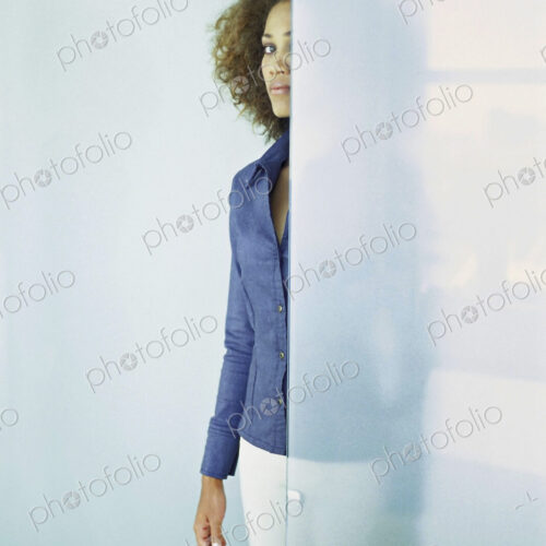 Black businesswoman standing behind glass wall Black businesswoman standing behind glass wall