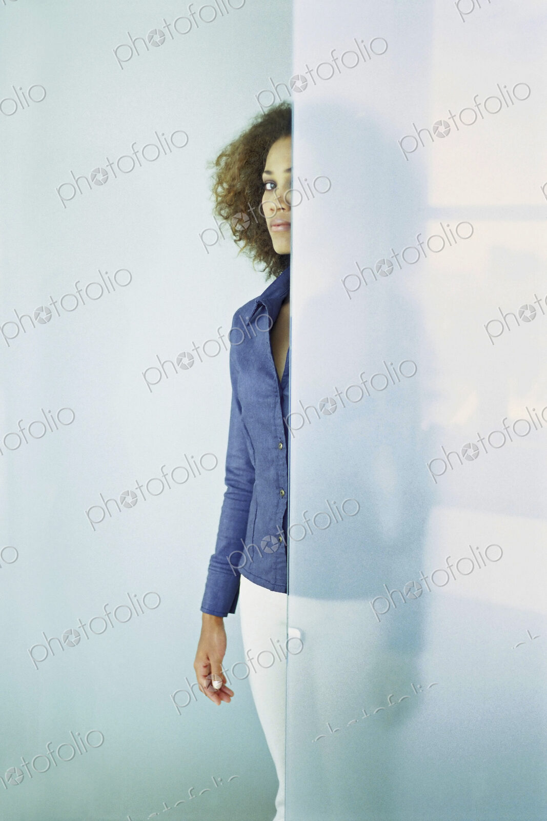 Black businesswoman standing behind glass wall