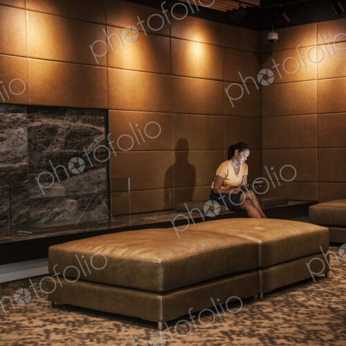 Black businesswoman working on a computer in a hotel lobby. Black businesswoman working on a computer in a hotel lobby.